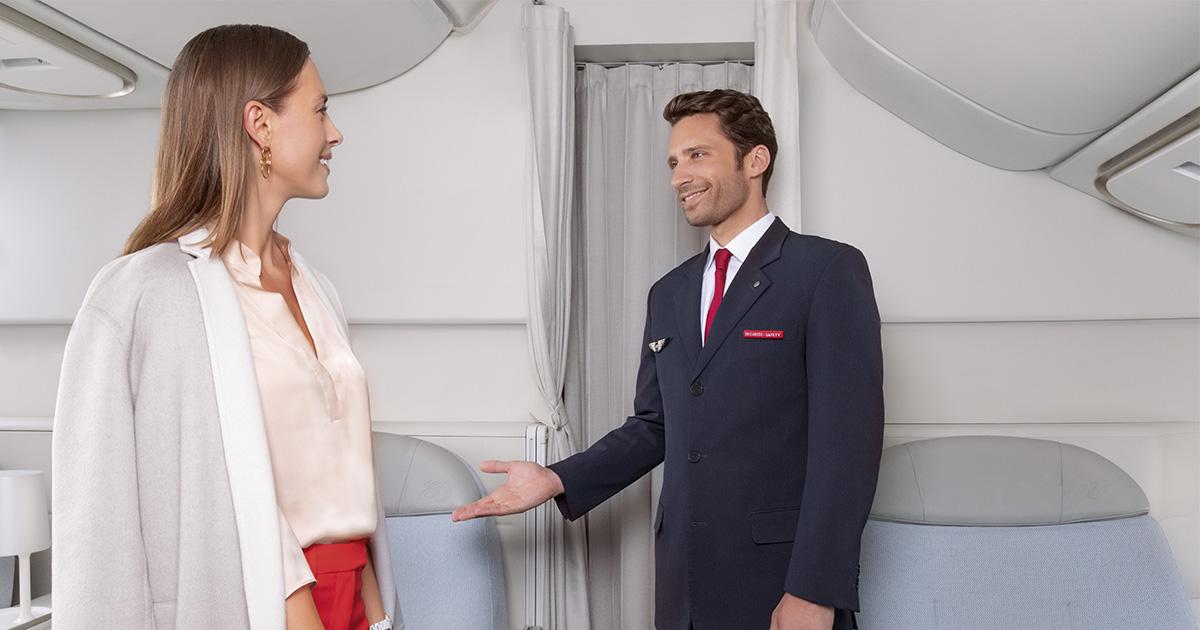 Air France male Cabin Crew with passenger.
