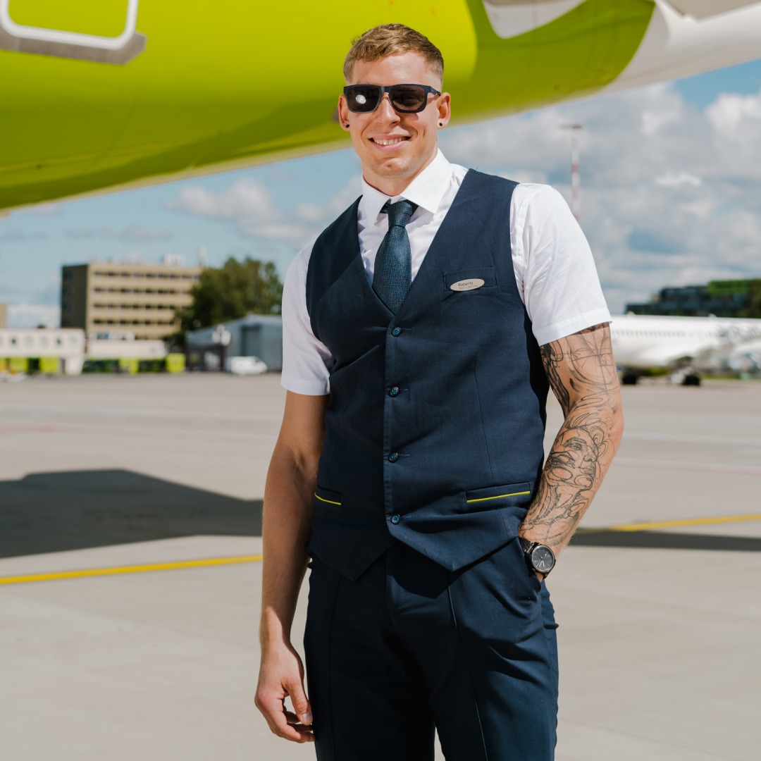 airBaltic male Cabin Crew with tattoos.