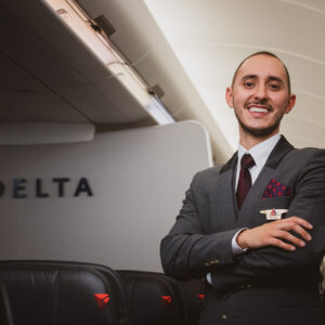 Delta male Flight Attendant in the cabin.