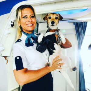 Air Europa female Cabin Crew holding a dog.