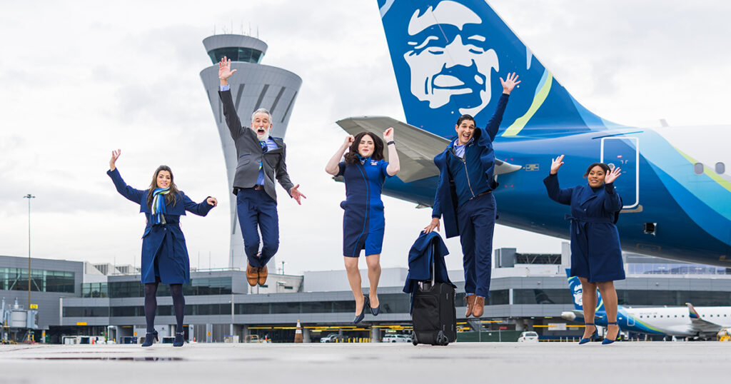 Alaska Airlines Flight Attendants jumping on tarmac.