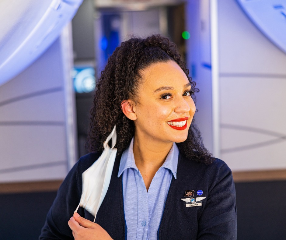 Alaska Airlines female Flight Attendant in the cabin.