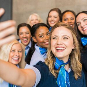 Alaska Airlines female Flight Attendant taking selfie.