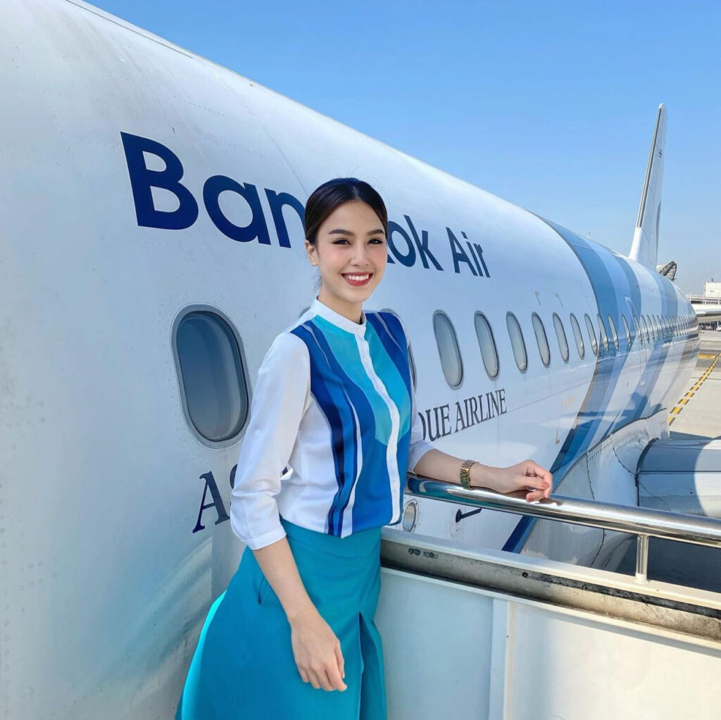 Bangkok Airways female Flight Attendant on stairs.