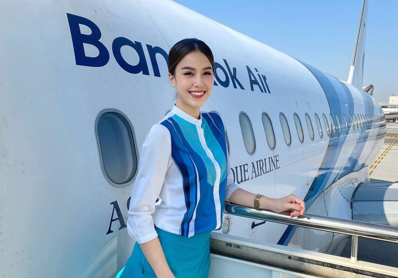 Bangkok Airways Cabin Crew member standing on stairs.