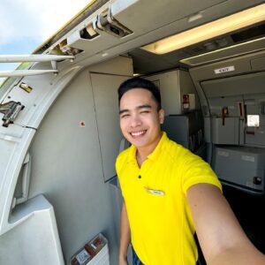 Cebu Pacific male Flight Attendant standing at the door.