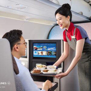 China Airlines female cabin crew serving meals.