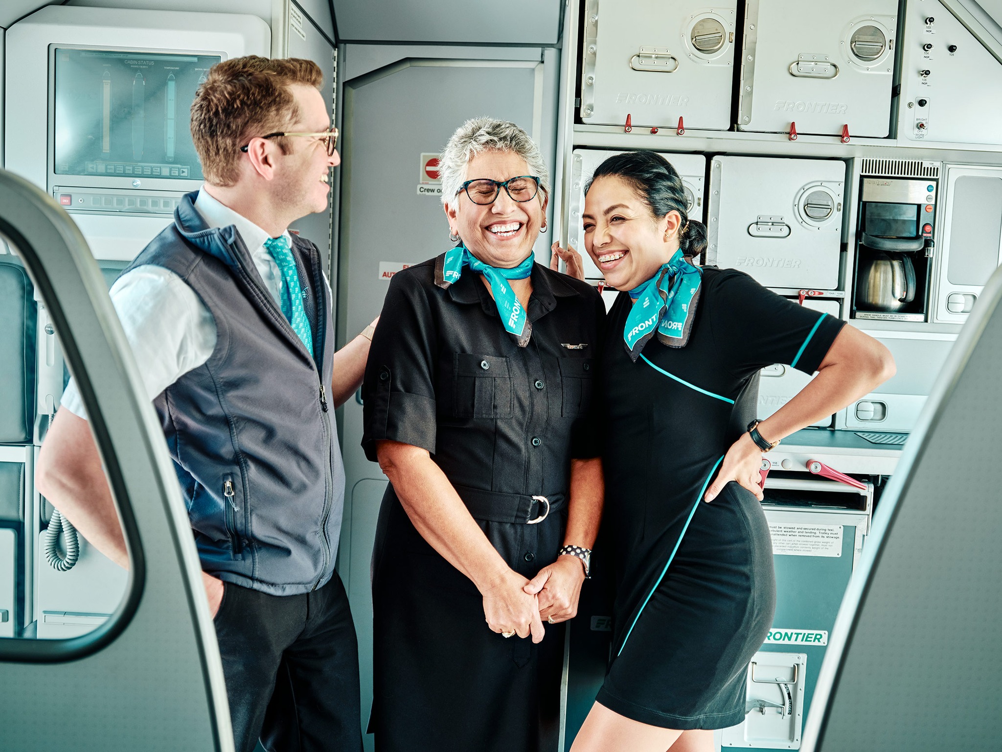 Frontier Airlines male and females Flight Attendants.