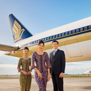 Singapore Airlines female and male flight attendants on the tarmac.