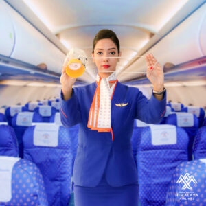 Himalaya Airlines female Cabin Crew performing safety demonstration.