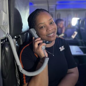 JetBlue female Flight Attendant using intercom.