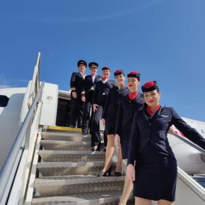 KM Malta Airlines Cabin Crew and Pilots on stairs.