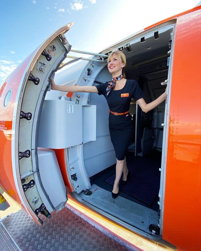 easyJet female Cabin Crew opening plane door.