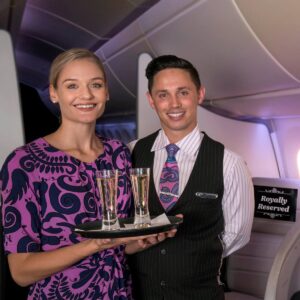 Air New Zealand Flight Attendants serving drinks.